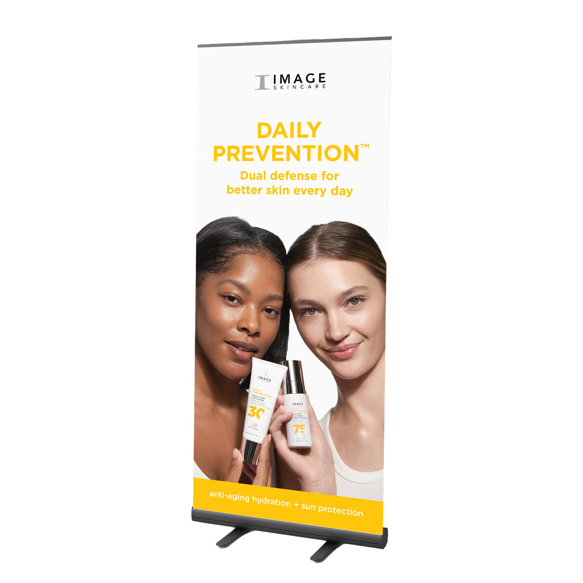 A floor banner featuring two models with skin care products, promoting 'Daily Prevention' by IMAGE Skincare.