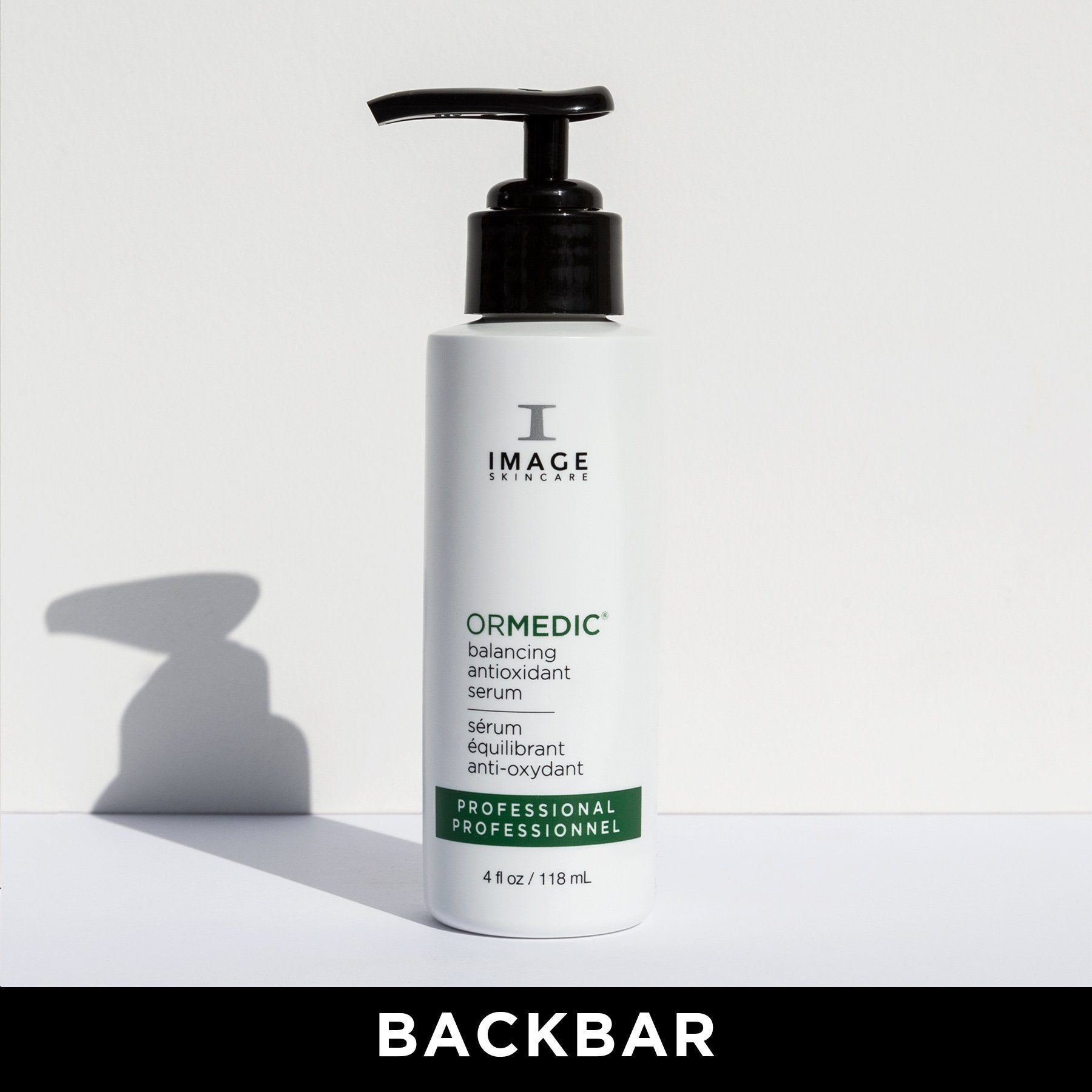 A pump bottle of IMAGE ORMedic balancing antioxidant serum on a white background with a shadow cast across the image.