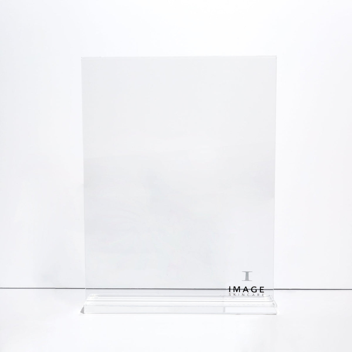 A clear acrylic counter stand with a printed label that reads 'IMAGE'.