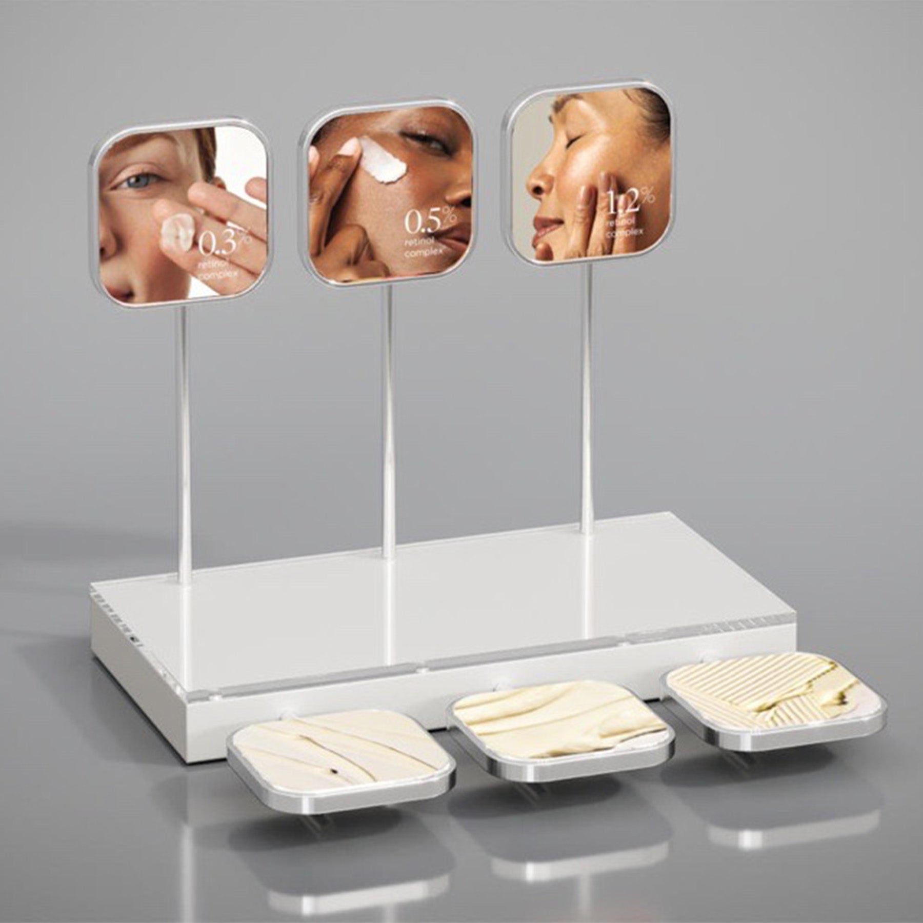 A counter tester display featuring AGELESS+ retinol crème with mirrors showing close-up images of skin before and after using the product.