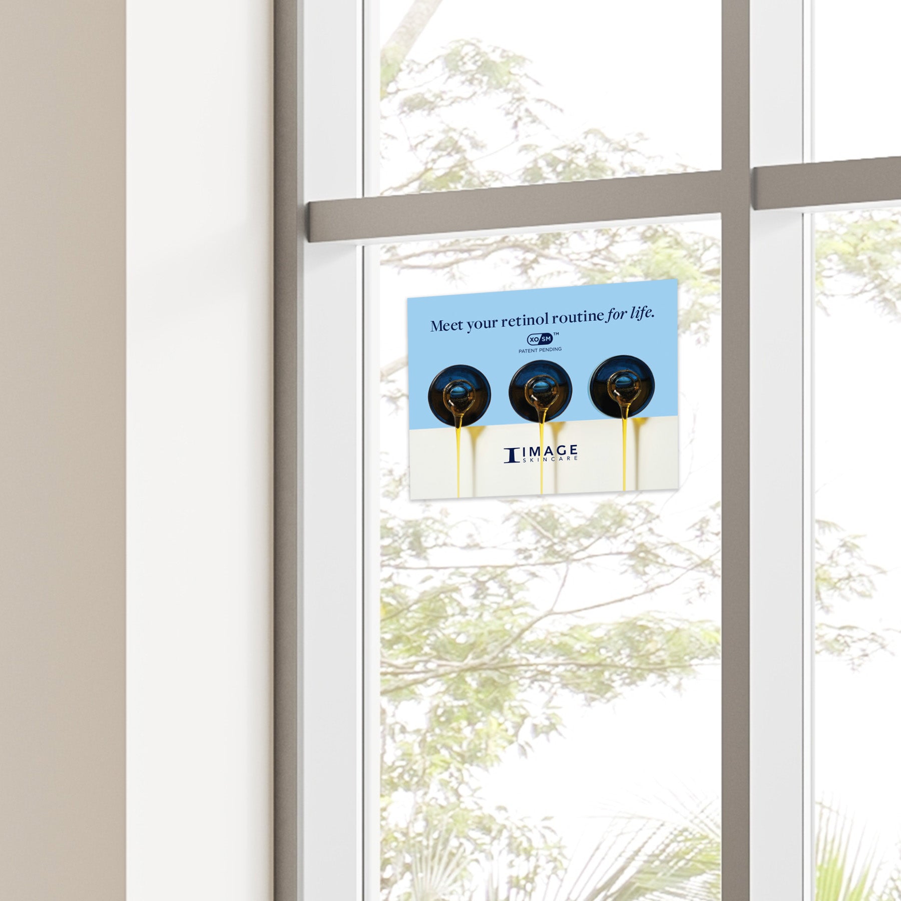 A window cling with the IMAGE Skincare logo and text inviting viewers to 'Meet your retinol routine for life.'