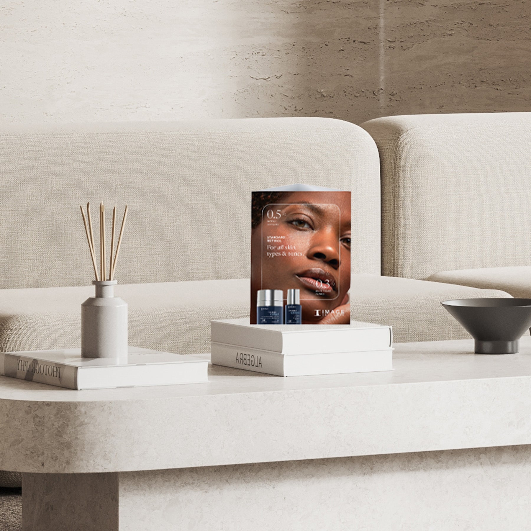 tent card displayed in office on top of a stack of books on a table