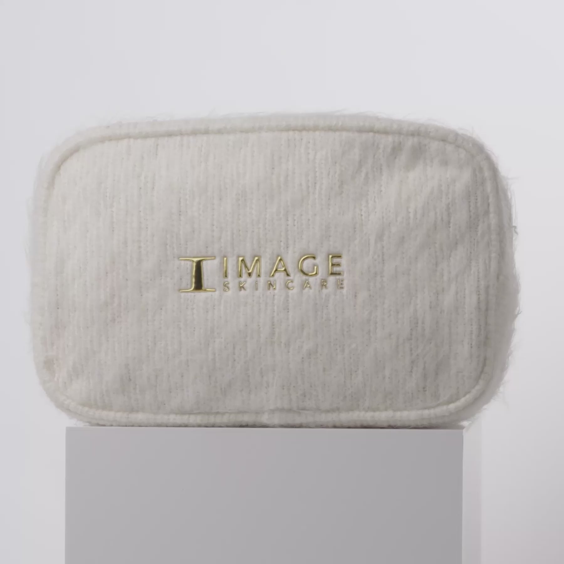 video of white bag and products spinning on block