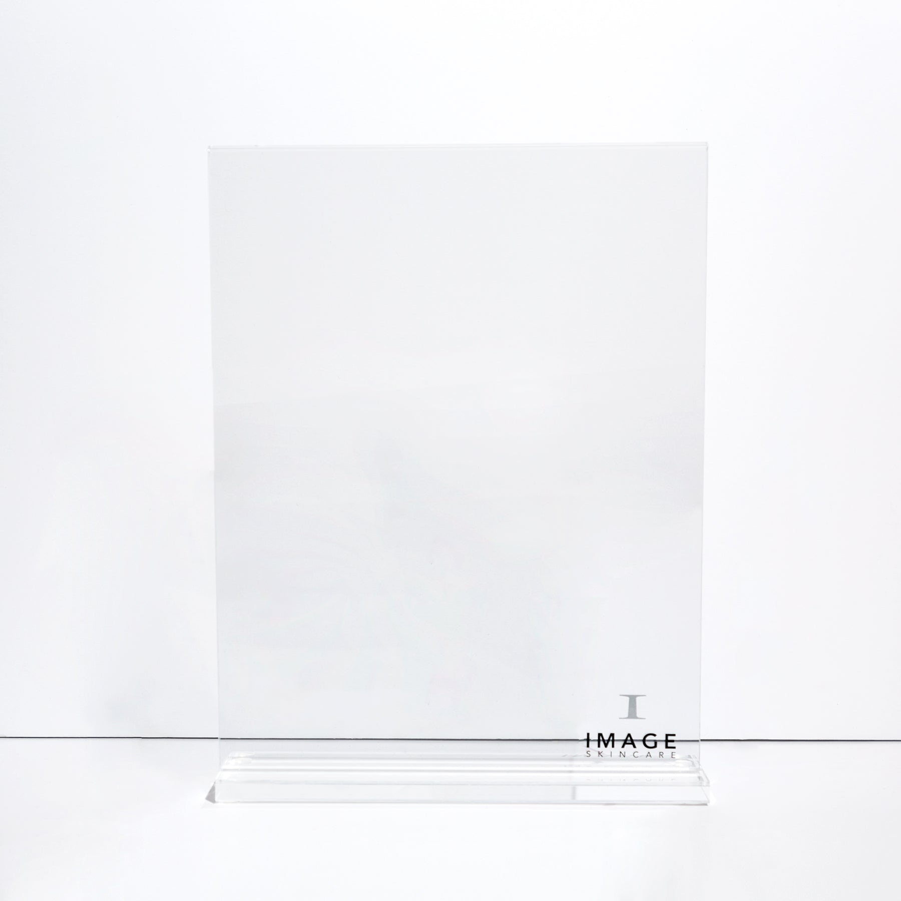 A clear acrylic counter stand with a printed label that reads 'IMAGE'.